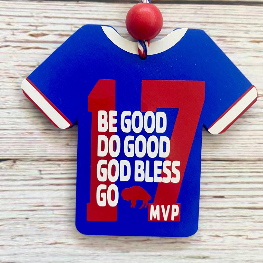 A wooden sports jersey ornament shaped like a blue football shirt with red and white trim, featuring the number 17 and the text 'BE GOOD DO GOOD GOD BLESS GO MVP' with a buffalo logo, hanging against a light wood background.